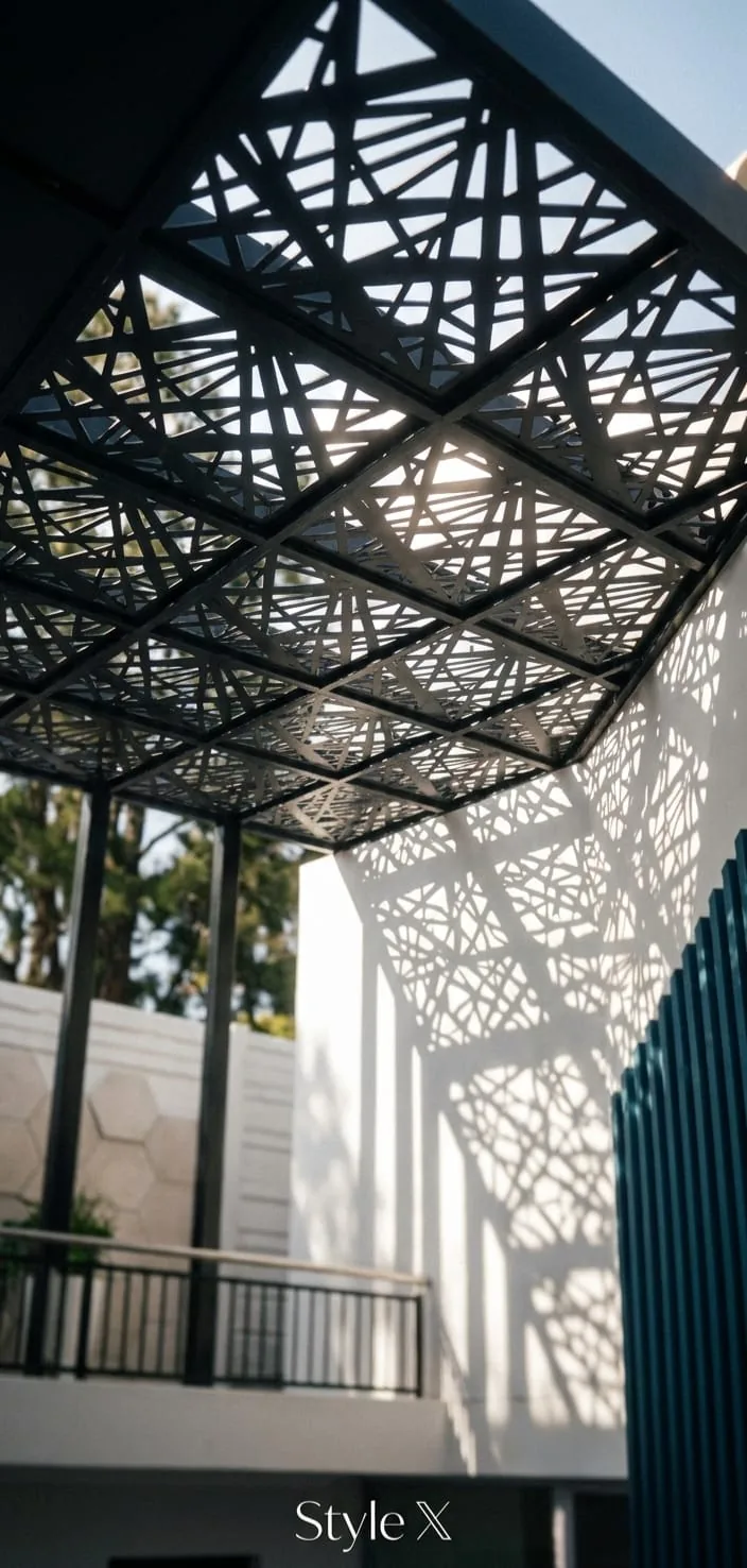 Black geometric cut pergola roof panels casting patterned shadows
